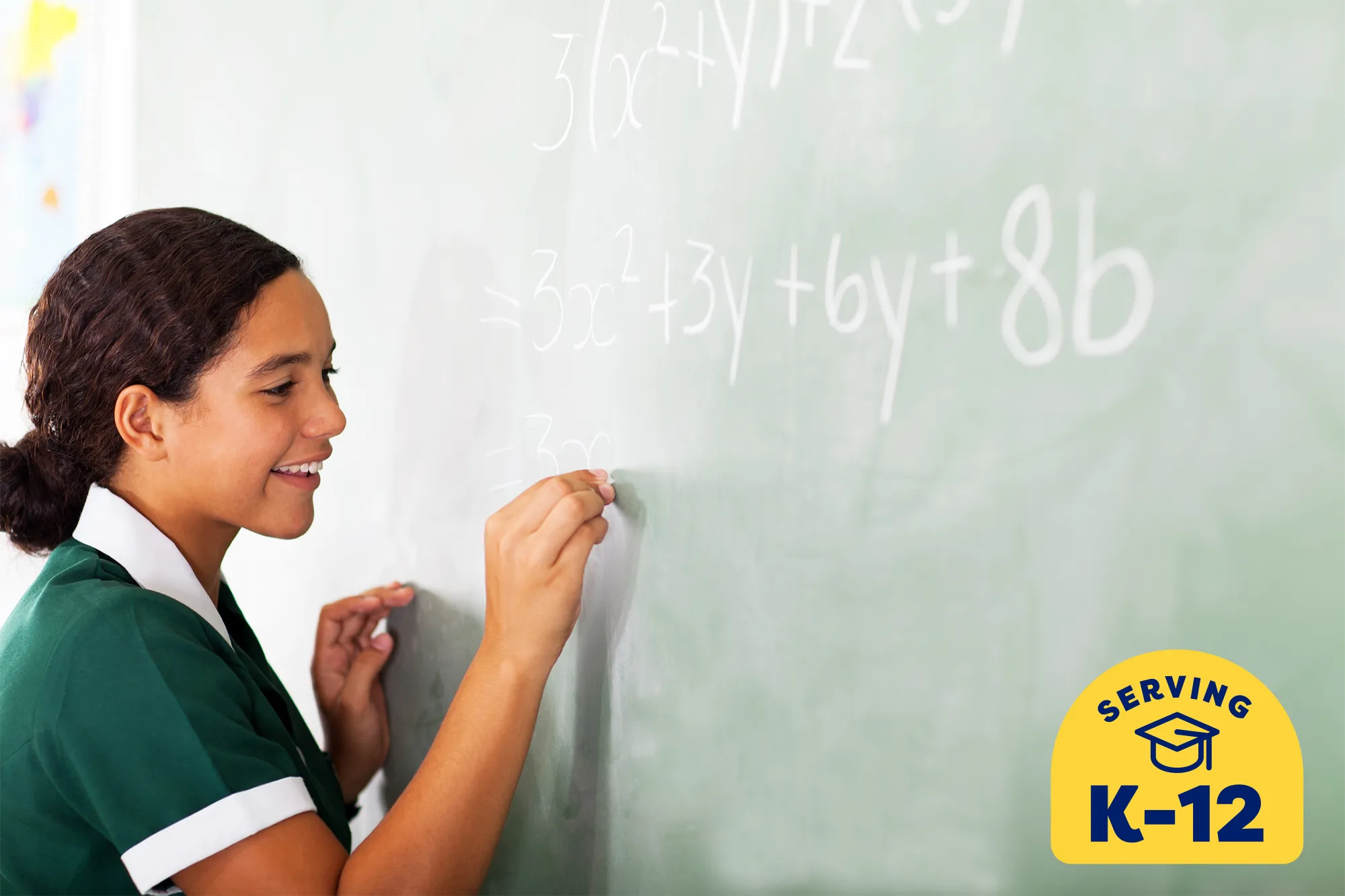 student writing her math problem out on a chalkboard