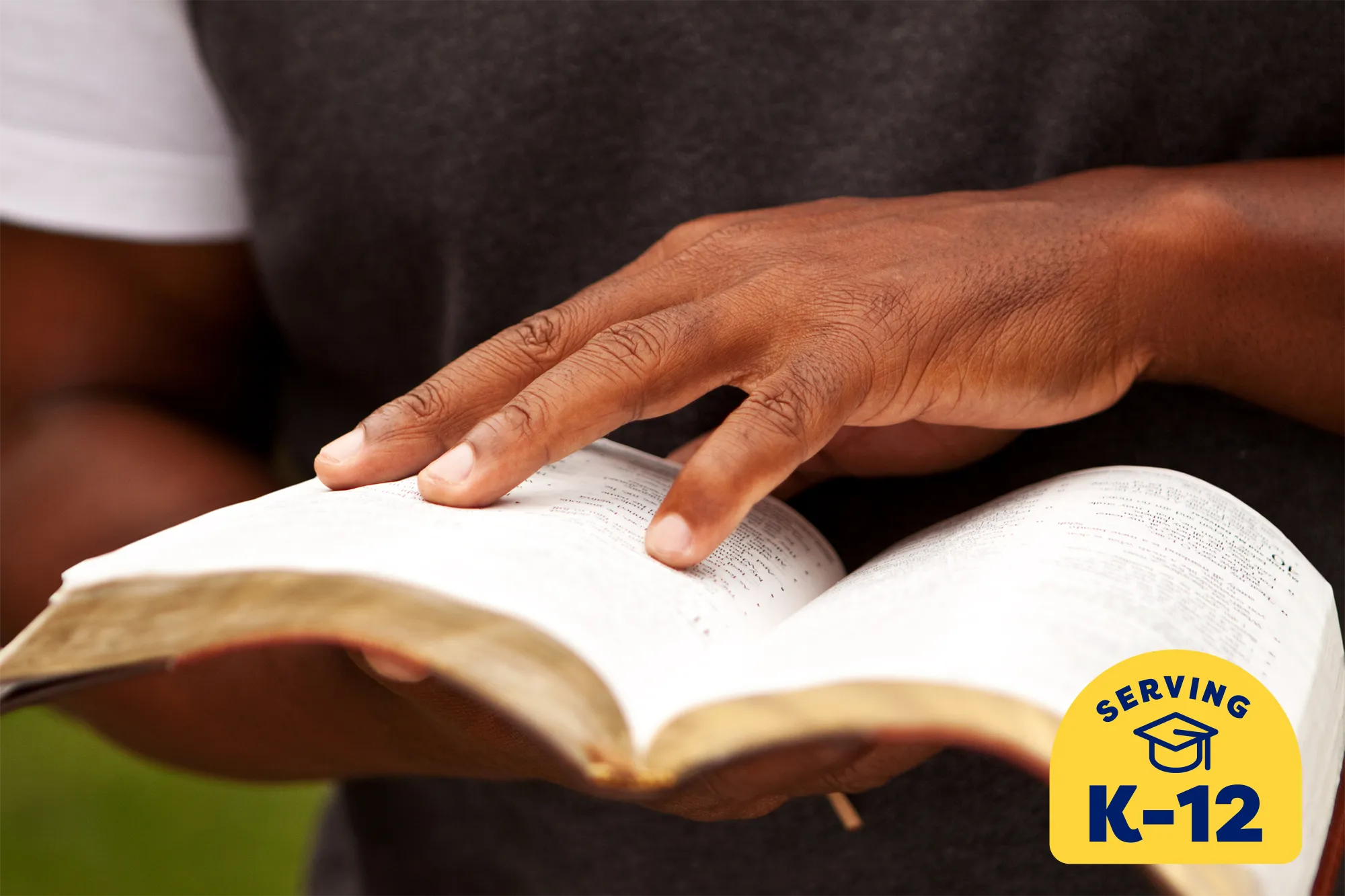 student holding and reading an old book