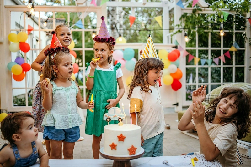 6 young girls celebrating at a birthday party